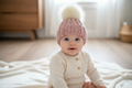 Pink beanie on clothed baby