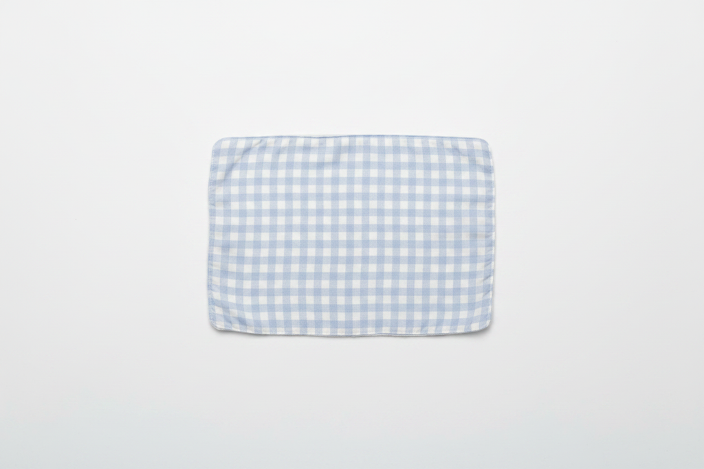 Professional flat lay of light blue gingham burp cloth