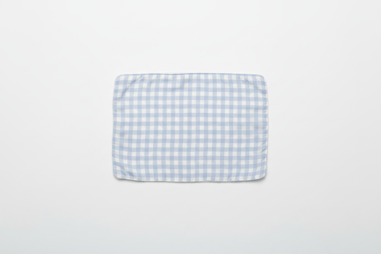 Professional flat lay of light blue gingham burp cloth